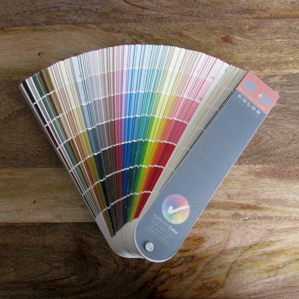 Colour Paint Chips Fanned out on a Wood Table